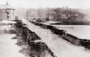 An early photograph of the 36 arch medievel Burton bridge that was replaced in 1863